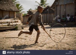 a-child-playing-with-a-wheel-in-vatomandry-district-madagascar-DM519C.jpg