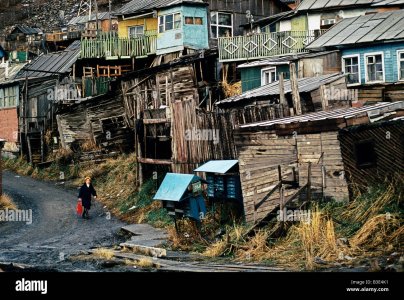 les-camps-de-siberie-magadan-woman-with-red-panier-passant-en-ruines-woodboard-building-1991-b...jpg