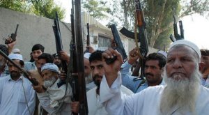 1-pakistani-tribal-militia-hold-their-weapons-as-they-patrol-together-with-security-forces-in-da.jpg